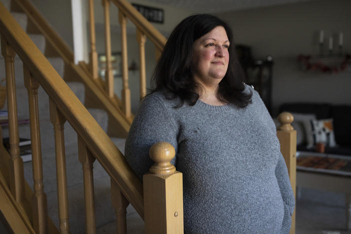 Lauren Barber stands in her home in Columbus, Ohio, on Nov. 16. Barber has been inundated with offers from investors and companies that want to buy her house. She sometimes gets called or texted more than five times a day with offers.