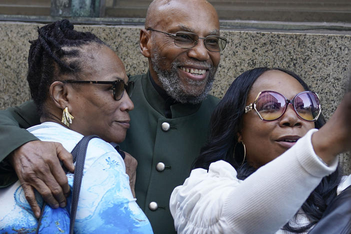 Muhammad Aziz, center, stands outside the courthouse with members of his family after his conviction in the killing of Malcolm X was vacated on Thursday in New York. A Manhattan judge dismissed the convictions of Aziz and the late Khalil Islam, after prosecutors and the lawyers said a renewed investigation found new evidence that the men were not involved with the killing.