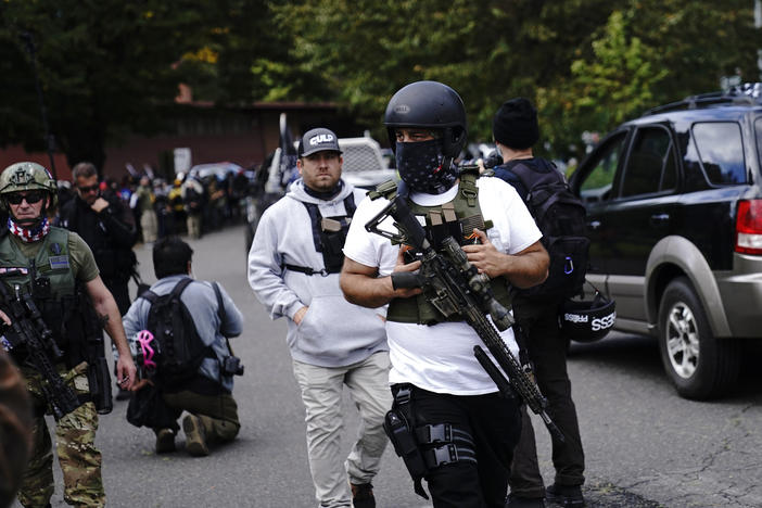 Armed participants walk at a Proud Boys rally with other right-wing demonstrators in September 2020 in Portland, Ore. Far-right groups celebrated the verdict in the Rittenhouse trial.