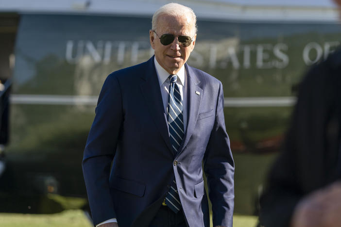 President Biden walks to speak with reporters as he returns to the White House Friday.