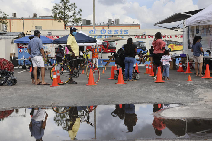 People line up to receive a rapid COVID-19 test in an agricultural community in Immokalee, Fla., where the poverty rate is over 40%. Partners in Health is working with the Coalition of Immokalee Workers to test, educate and vaccinate the community during the pandemic.