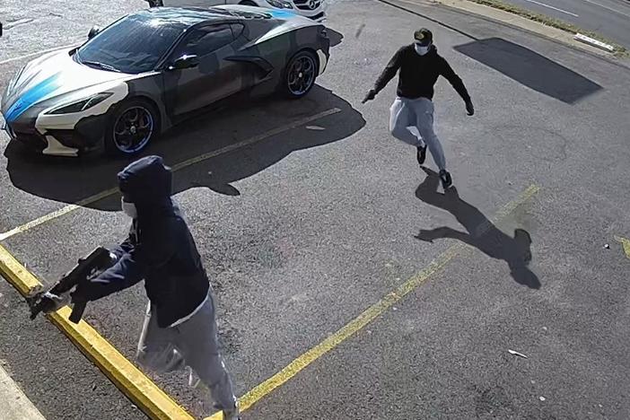 The Memphis Police Department attained surveillance video showing two armed suspects getting out of a white two-door Mercedes Benz and approaching rapper Young Dolph while he was inside Makeda's Cookies.