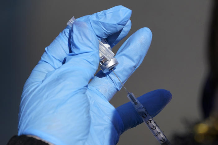A nurse fills a syringe with COVID-19 vaccine at a mass vaccination site in Kansas City, Mo. on March 19, 2021.