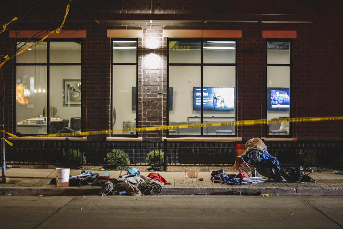 Debris litters the street at a crime scene on Sunday in Waukesha, Wis., after a person in an SUV slammed into pedestrians at a Christmas parade.