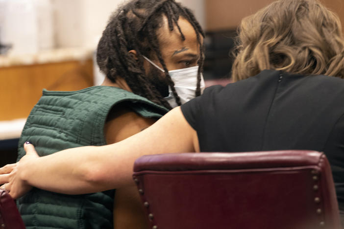 Darrell Brooks, left, speaks with a lawyer during his initial appearance, Tuesday, Nov. 23, 2021 in Waukesha County Court in Waukesha, Wis. Brooks is charged with intentional homicide after SUV was driven into a Christmas parade.