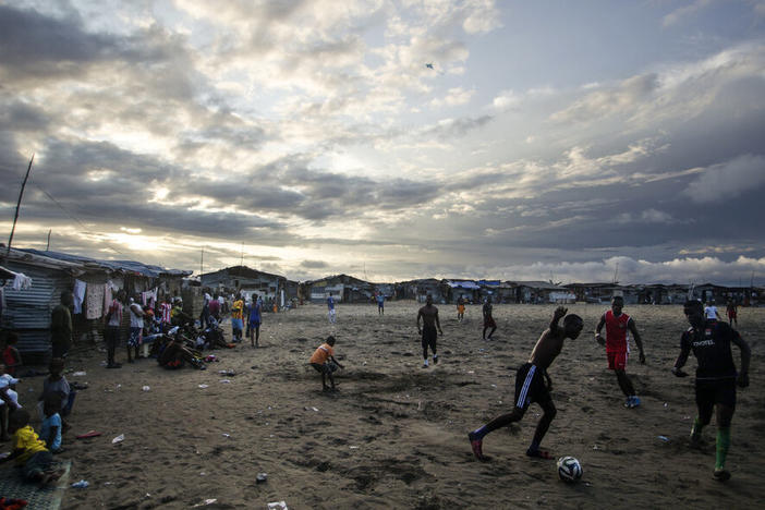 Thanksgiving is a day at the beach — quite literally — for young Liberians. Above, the beach in West Point is a sandy playing field for soccer lovers.