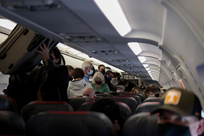 Passengers deplane from an airplane after landing at the Albuquerque International Sunport on Nov. 24, 2021 in Albuquerque, New Mexico.