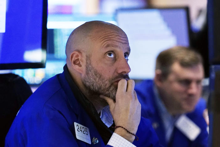 Specialist Meric Greenbaum, left, works at his post on the floor of the New York Stock Exchange on Black Friday. Stocks dropped after a coronavirus variant appears to be spreading across the globe.