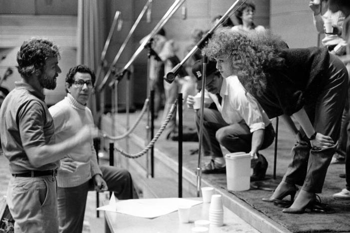 Bernadette Peters leans forward to discuss the recording of the "Sunday in the Park with George" album with Stephen Sondheim and producer Thomas Z. Shepard in June 1984.