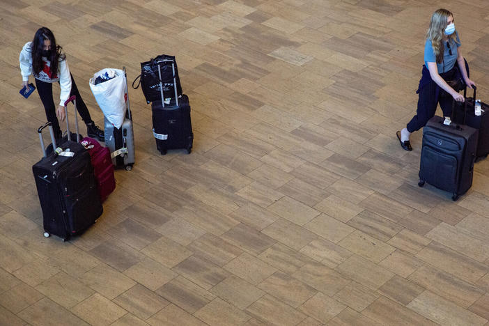 Travelers wearing protective face masks arrive to Ben Gurion Airport near Tel Aviv, Israel on Sunday. Israel on Sunday approved barring entry to foreign nationals as part of its efforts to clamp down on a new coronavirus variant.
