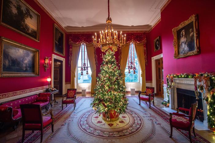 A Christmas tree stands in the Red Room during a press preview of White House holiday decorations on Nov. 29.