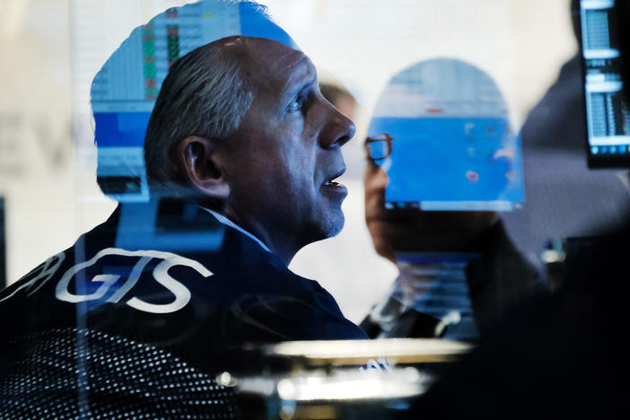 Traders work on the floor of the New York Stock Exchange at the start of trading on Monday following Friday's steep decline in global stocks over fears of the new omicron coronavirus variant discovered in South Africa.