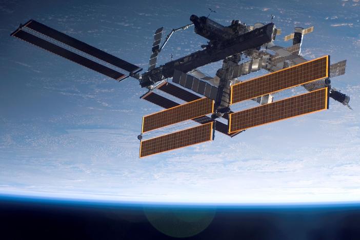 International Space Station is seen over a blue and white Earth, taken shortly after the Space Shuttle Atlantis undocked from the orbital outpost.