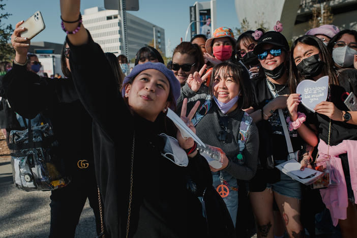 Two separate groups of fans from the Philippines take a photo together before the BTS concert at SoFi Stadium in Inglewood, Calif., on Nov. 27.