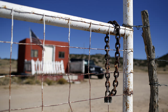 A rusted chain hangs on the fence at the entrance to the Bonanza Creek Ranch film set in Santa Fe, N.M., on Oct. 27.