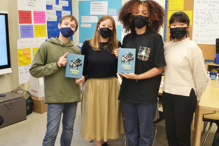 Three of the student authors of <em>Who Is Florence Price? </em>(left to right: Sebastián Núñez, Hazel Peebles and Sophia Shao), joined by their English teacher, Shannon Potts.