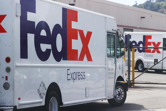FedEx trucks are parked at a FedEx Ship Center on September 22, 2021 in Los Angeles, California. FedEx says the driver who dumped packages into an Alabama ravine at least six times is no longer with the company.