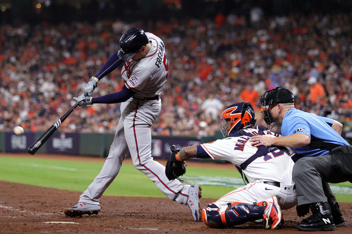 Freddie Freeman of the Atlanta Braves hits a home run against the Houston Astros during Game 6 of the 2021 World Series. A report by Business Insider found that the league used two different types of baseballs during the 2021 season, one of which flew farther.