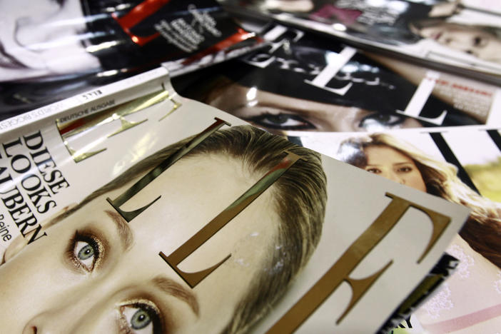 A file picture taken in January 2011 in Paris shows covers of some of the 42 foreign editions of the French fashion magazine "Elle", owned by French media conglomerate Lagardere.