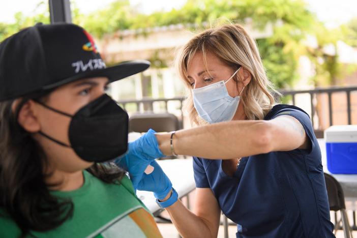 A nurse administers a dose of the Pfizer COVID-19 vaccine during a City of Long Beach Public Health mobile vaccination clinic at the California State University, Long Beach campus.