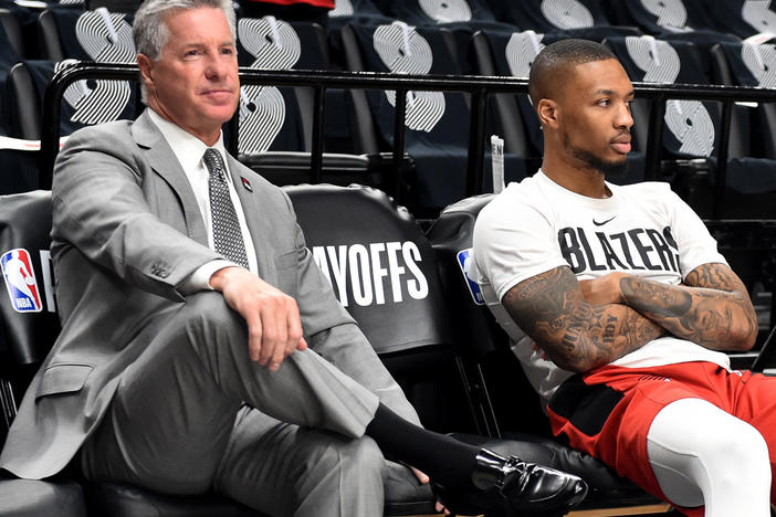 The Portland Trail Blazers fired Neil Olshey on Friday, after workers reportedly accused him of creating a hostile work environment. He's seen here sitting near Damian Lillard in 2019.