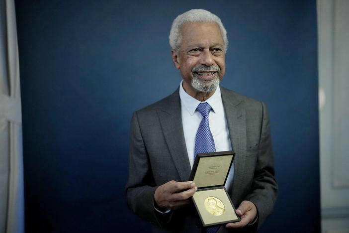 Abdulrazak Gurnah, a Tanzanian-born novelist and academic who lives in the U.K., poses with his 2021 Nobel Prize in Literature medal after being presented it at the Swedish ambassador's residence in London.