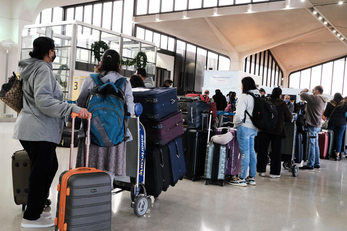 Travelers arrive for flights at Newark Liberty International Airport in New Jersey on Nov. 30.