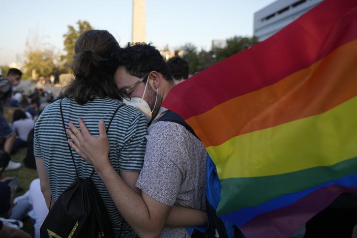 Members of the Movilh — Movement for Homosexual Integration and Liberation — celebrate after lawmakers approved legislation legalizing marriage and adoption by same-sex couples, in Santiago, Chile, on Tuesday.