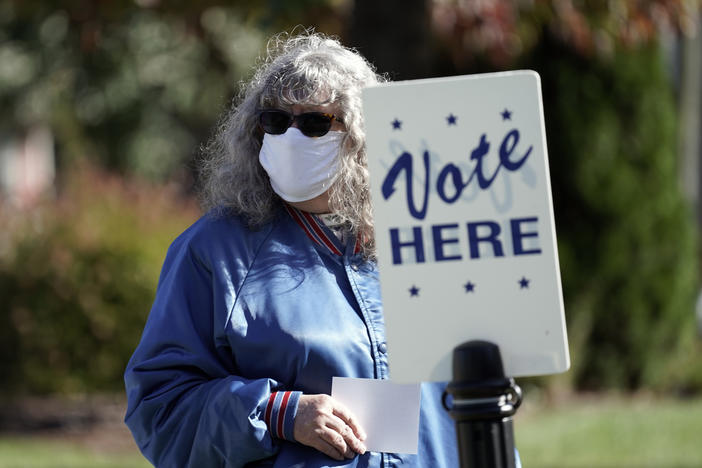 A voter waits to cast a ballot at a polling location in Graham, N.C., Nov. 3, 2020. On Wednesday the North Carolina Supreme Court delayed the 2022 statewide primaries by two months to give redistricting legal challenges more time to be heard.