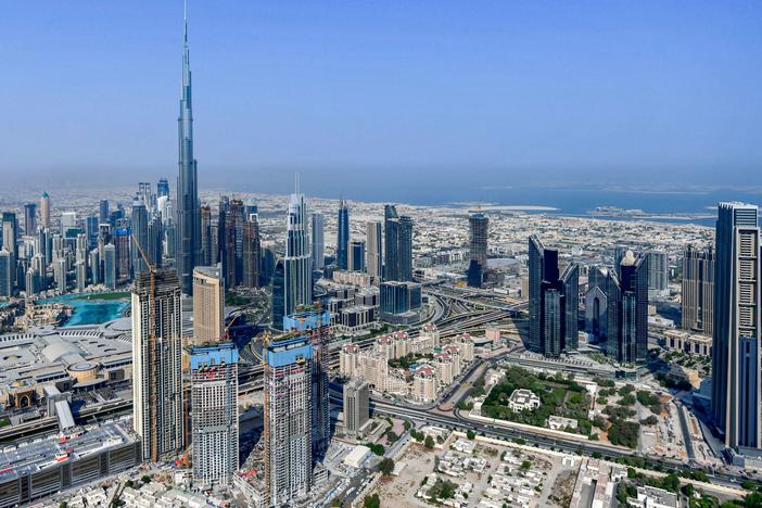 The United Arab Emirates is changing its workweek to have half days on Fridays and a Saturday-Sunday weekend. Here, the country's emirate of Dubai and its Burj Khalifa skyscraper are photographed from a helicopter on July 8, 2020.