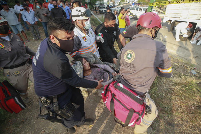An injured migrant woman is moved by rescue personnel from the site of an accident near Tuxtla Gutierrez, Chiapas state, Mexico, on Thursday.
