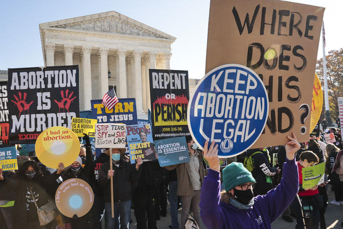 Demonstrators gather in front of the Supreme Court as the justices hear arguments earlier this month in <em>Dobbs v. Jackson Women's Health</em>, a case about a Mississippi law that bans most abortions after 15 weeks.
