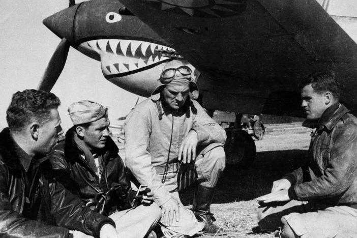 Pilots from the American Volunteer Group sit in front of a P-40 airplane in Kunming, China, on March 27, 1942. The group was notable for its unusual mission: Its members were mercenaries hired by China to fight against Japan.
