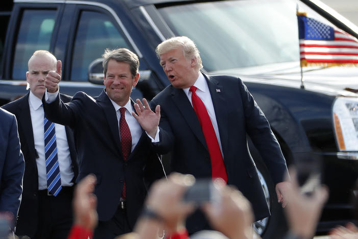 Georgia Republican Gov. Brian Kemp, at the time a candidate for governor, walks with then-President Trump as Trump arrives for a rally in Macon, Ga. on Nov. 4, 2018, just days before the election. Sour on Kemp, Trump is now backing former U.S. Senator David Perdue for the 2022 GOP primary for governor.