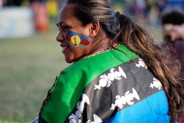 An independence supporter with a flag of the Socialist Kanak National Liberation Front (FLNKS) on October 1, 2020.