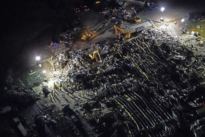 In this aerial photo, a collapsed factory is seen with workers searching for survivors in Mayfield, Ky., on Saturday, after tornadoes came through the area the previous night.