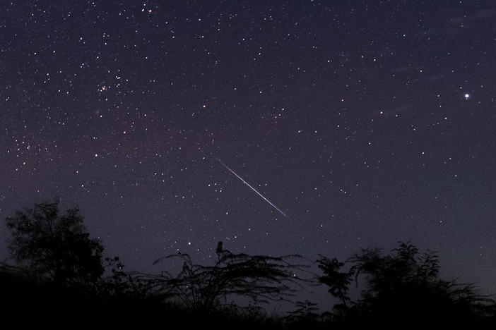 This photo taken late on Dec. 14, 2018, with a long time exposure shows a meteor streaking through the night sky over Myanmar during the Geminid meteor shower, seen from Wundwin township near the city of Mandalay.