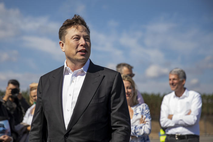 Tesla head Elon Musk talks to the press as he arrives to to have a look at the construction site of the new Tesla Gigafactory near Berlin last year.