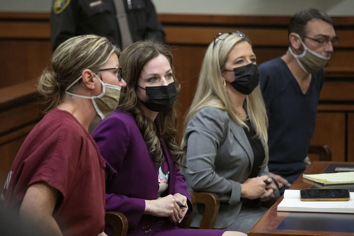 James Crumbley, far right, and Jennifer Crumbley, far left, sit with their attorneys in district court in Rochester Hills, Mich., on Tuesday for a probable cause conference in the case of the Oxford High School mass shooting.