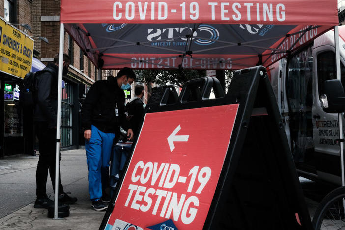 A COVID-19 pop-up testing site stands on a Manhattan street in October in New York City. On Tuesday, Pfizer released promising data about a pill to treat COVID-19.