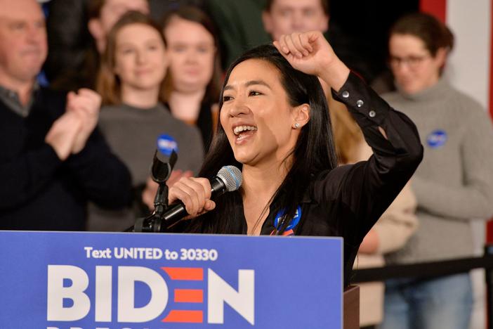 Former Olympian Michelle Kwan speaks before then-candidate Joe Biden at a rally in Manchester, N.H., on Feb. 8, 2020. On Wednesday President Biden said he'll nominate Kwan for ambassador to Belize.