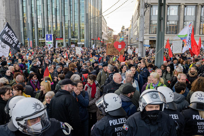 Police stand in front of protesters during a demonstration of Germany's "Querdenker" (Lateral Thinkers) movement in November, in Leipzig, eastern Germany.