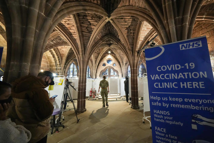 The fast spread of omicron has led many wealthy countries to speed up vaccine rollout and widen booster programs. Here, British soldiers administer shots at a vaccine clinic at Chester Cathedral in Manchester, England, on Wednesday.