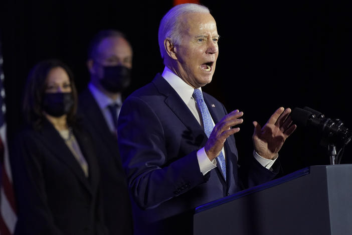 President Biden speaks at a Democratic National Committee holiday party on Tuesday in Washington, as Vice President Kamala Harris and second gentleman Doug Emhoff listen. The Biden Administration announced its action plan this week to replace the country's lead pipes, which impacts up to 10 million households.