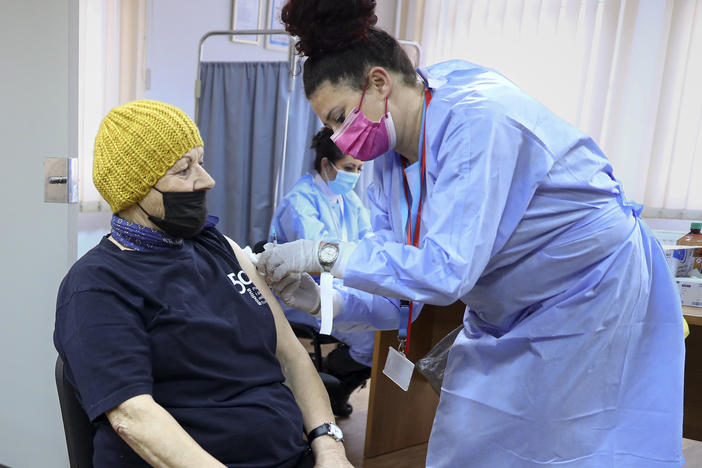 A woman is administered a COVID-19 vaccine at a center on the outskirts of Sarajevo. Bosnia has so far inoculated just under a quarter of its 3.3 million people, one of the lowest rates in Europe.