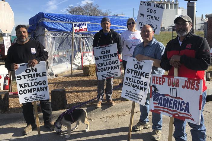 Striking Kellogg's workers stand outside the Omaha, Neb., cereal plant on, Dec. 2. The company reached a new tentative agreement on Thursday, with its 1,400 cereal plant workers that could bring an end to the strike that began Oct. 5.