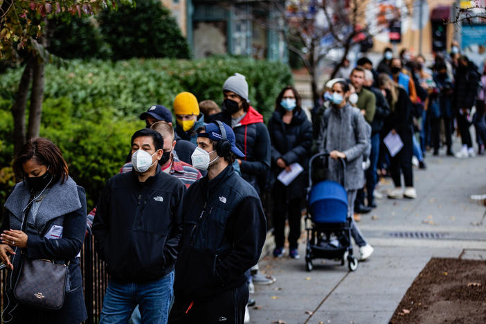 People line up outside a free COVID-19 vaccination site on Dec. 3 in Washington, D.C. Many areas are stepping up vaccination and booster shots as more cases of the omicron variant of the coronavirus are detected in the United States.
