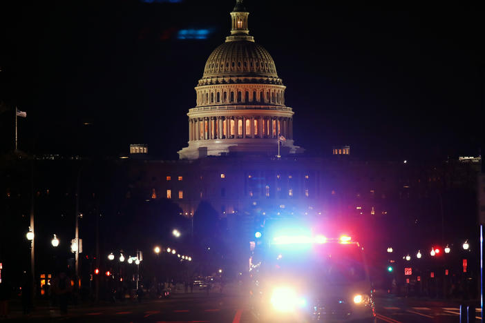 A police car drives away from the U.S. Capitol on Jan. 6, 2021.