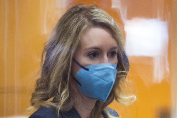 Elizabeth Holmes walks into federal court in San Jose, Calif., Friday, Dec. 17, 2021.