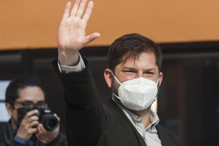 Ahead of his victory, presidential candidate Gabriel Boric, of the "I approve Dignity" coalition, is seen waving to supporters at a polling station during the presidential run-off election in Punta Arenas, Chile, on Sunday.